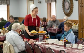 An Amish waitress serves lunch at Tiffany's Restaurant in Topeka, Indiana.