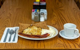 Fried eggs, bacon, hash browns, and toast at Tiffany's Restaurant in Topeka, Indiana.